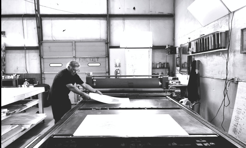 Vladimir Schuster working on his Dufa printing press.